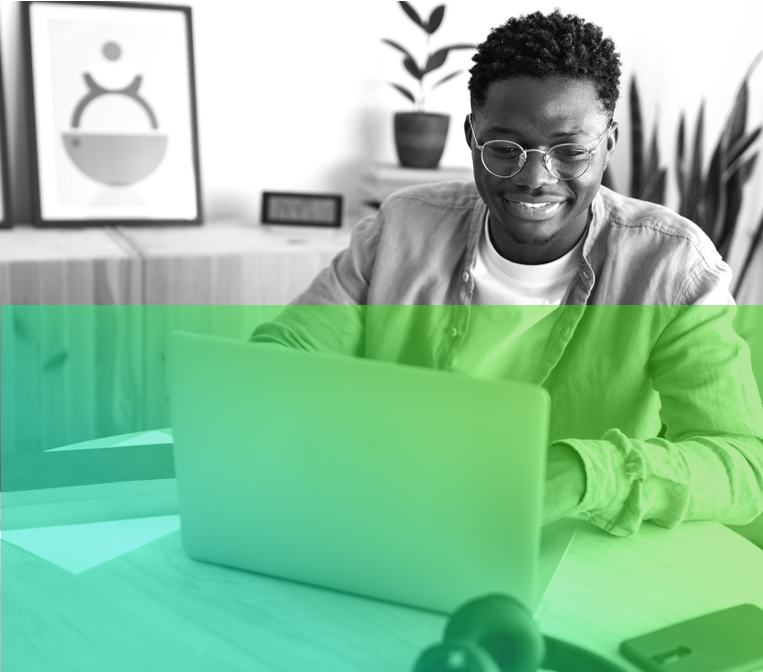 image of male sitting down using computer with green gradient.