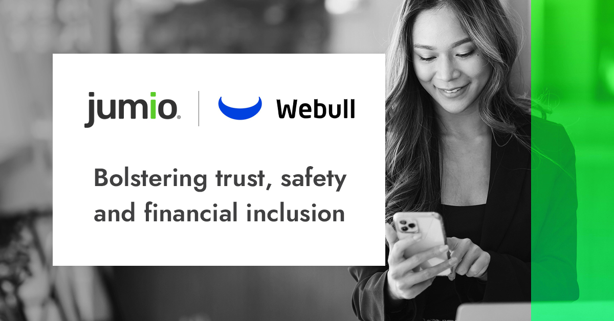 image of woman in background holding smart device. Webull logo and Jumio logo. Text reads: bolstering trust, safety and financial inclusion with Jumio.